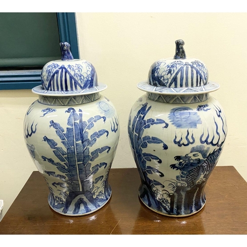 13 - A PAIR OF CHINESE PORCELAIN BLUE AND WHITE TEMPLE VASES, c. late Qing period, with domed cover with ... 