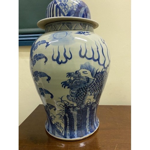 13 - A PAIR OF CHINESE PORCELAIN BLUE AND WHITE TEMPLE VASES, c. late Qing period, with domed cover with ... 