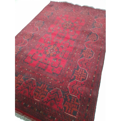 146 - AN AUTHENTIC AFGHAN KHAN MOHAMMADI RUG, hand-woven in the traditional Khan Mohammadi pattern in vibr... 