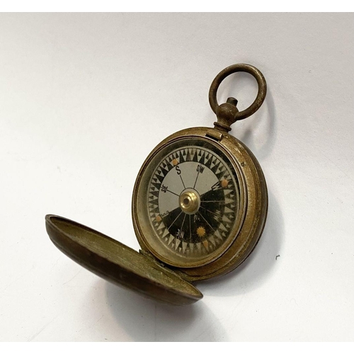 155 - AN ANTIQUE BRASS EXPLORERS STYLE POCKET COMPASS, likely a Singer’s Patent compass as it features Sin... 