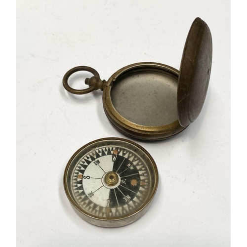 155 - AN ANTIQUE BRASS EXPLORERS STYLE POCKET COMPASS, likely a Singer’s Patent compass as it features Sin... 