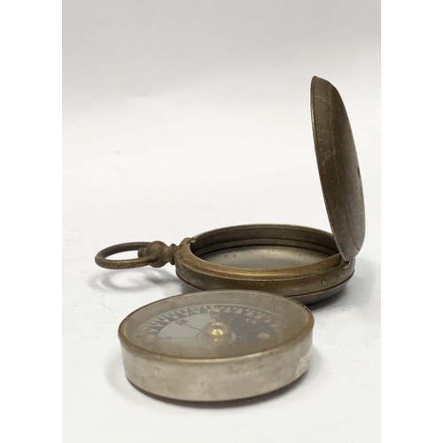 155 - AN ANTIQUE BRASS EXPLORERS STYLE POCKET COMPASS, likely a Singer’s Patent compass as it features Sin... 