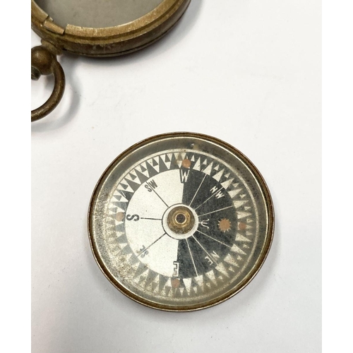 155 - AN ANTIQUE BRASS EXPLORERS STYLE POCKET COMPASS, likely a Singer’s Patent compass as it features Sin... 