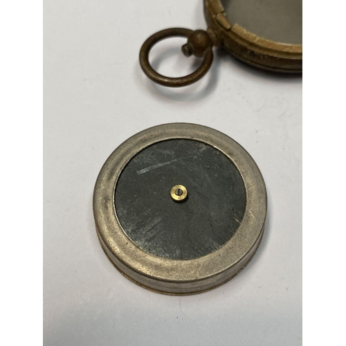 155 - AN ANTIQUE BRASS EXPLORERS STYLE POCKET COMPASS, likely a Singer’s Patent compass as it features Sin... 