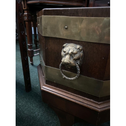 17 - A GOOD QUALITY REGENCY BRASS BOUND MAHOGANY WINE COOLER, octagonal in shape, with liner, lion head b... 