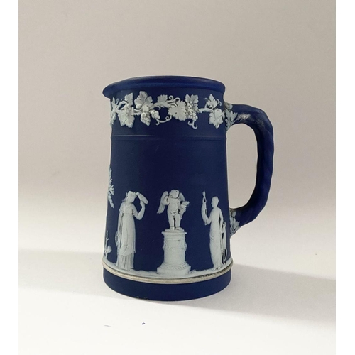 181 - AN ANTIQUE BLUE JASPERWARE SMALL PITCHER, by Wedgewood. Decorated with applied white classical scene... 