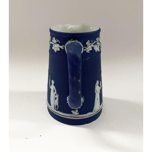 181 - AN ANTIQUE BLUE JASPERWARE SMALL PITCHER, by Wedgewood. Decorated with applied white classical scene... 