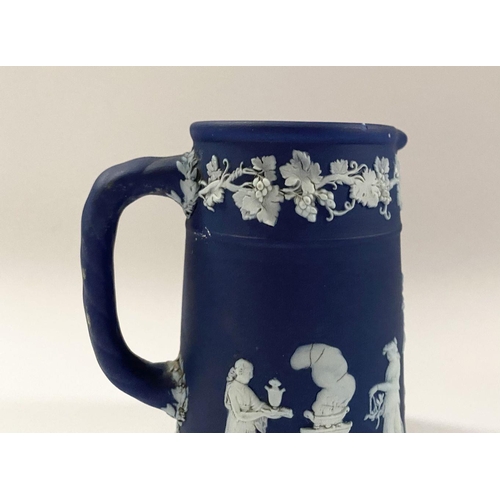 181 - AN ANTIQUE BLUE JASPERWARE SMALL PITCHER, by Wedgewood. Decorated with applied white classical scene... 