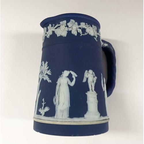 181 - AN ANTIQUE BLUE JASPERWARE SMALL PITCHER, by Wedgewood. Decorated with applied white classical scene... 