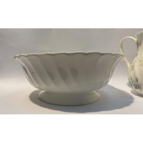 185 - A WEDGWOOD BONE CHINA JUG AND BOWL IN THE ROSEHIP PATTERN, both marked to base, in good condition. D... 