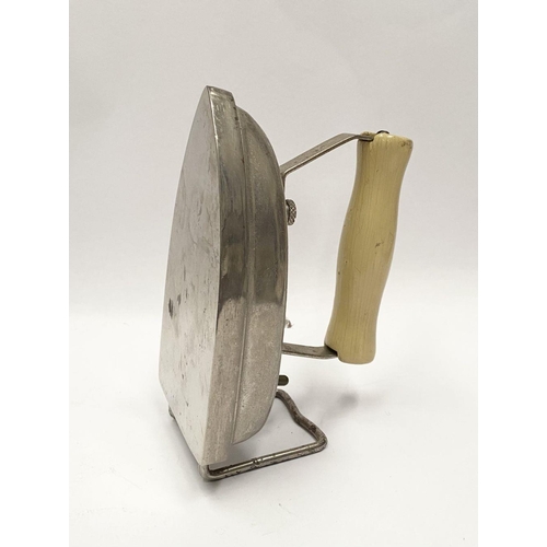 216 - A VINTAGE ELECTRIC TRAVELLING IRON, c.1950, of typical form with detachable cream handle. Dimensions... 