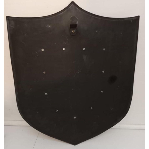 47 - A LARGE DECORATIVE METAL SHIELD, with lion decoration. Dimensions: 63cm high 45cm wide.