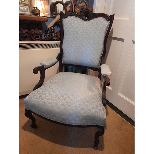 49 - AN EARLY 20TH CENTURY MAHOGANY FRAMED LOW RISE ARM CHAIR, with nicely carved crest rail, and scrolli... 