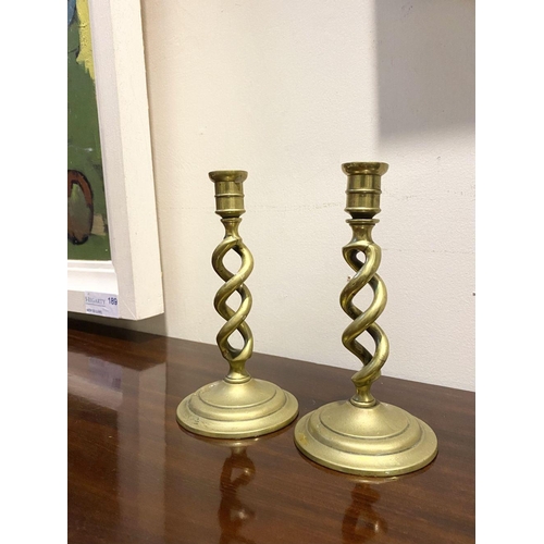 54 - A PAIR OF BRONZE TWIST CANDLESTICKS, on circular bases, dimensions: 18cm high x 9.5cm diameter base ... 