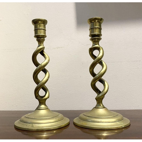 54 - A PAIR OF BRONZE TWIST CANDLESTICKS, on circular bases, dimensions: 18cm high x 9.5cm diameter base ... 