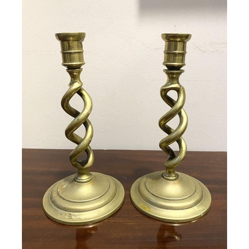 54 - A PAIR OF BRONZE TWIST CANDLESTICKS, on circular bases, dimensions: 18cm high x 9.5cm diameter base ... 