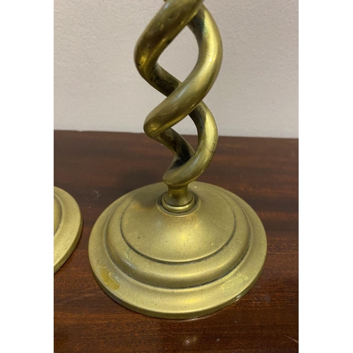 54 - A PAIR OF BRONZE TWIST CANDLESTICKS, on circular bases, dimensions: 18cm high x 9.5cm diameter base ... 