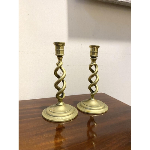 54 - A PAIR OF BRONZE TWIST CANDLESTICKS, on circular bases, dimensions: 18cm high x 9.5cm diameter base ... 