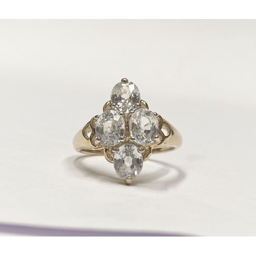 63 - A STRIKING 9CT YELLOW GOLD FOUR STONE CLUSTER RING, with four oval cut sparking clear gemstones in f... 