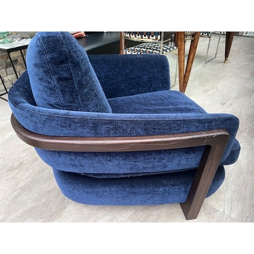 75 - A CONTEMPORARY PORADA ARMCHAIR, with beautiful blue velvet upholstery, and a stained beech frame. 83... 