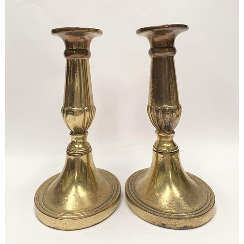 78 - A FINE PAIR OF BRASS CANDLESTICKS, with fluted design to support, atop platform oval bases. Marked M... 