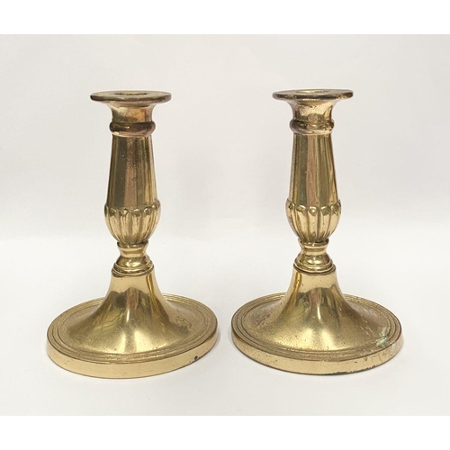 78 - A FINE PAIR OF BRASS CANDLESTICKS, with fluted design to support, atop platform oval bases. Marked M... 