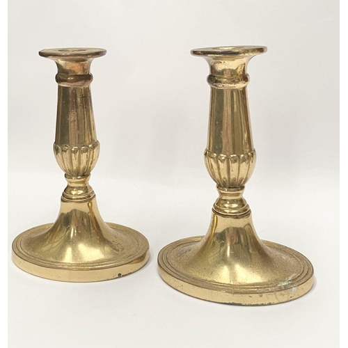 78 - A FINE PAIR OF BRASS CANDLESTICKS, with fluted design to support, atop platform oval bases. Marked M... 