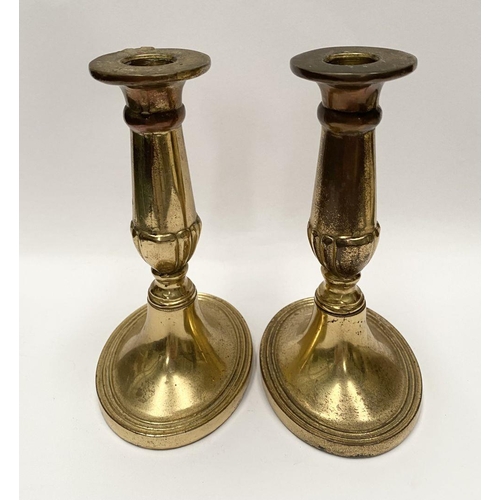 78 - A FINE PAIR OF BRASS CANDLESTICKS, with fluted design to support, atop platform oval bases. Marked M... 