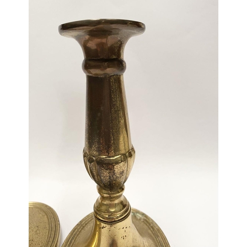 78 - A FINE PAIR OF BRASS CANDLESTICKS, with fluted design to support, atop platform oval bases. Marked M... 