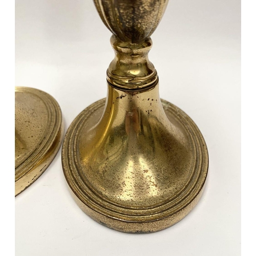 78 - A FINE PAIR OF BRASS CANDLESTICKS, with fluted design to support, atop platform oval bases. Marked M... 