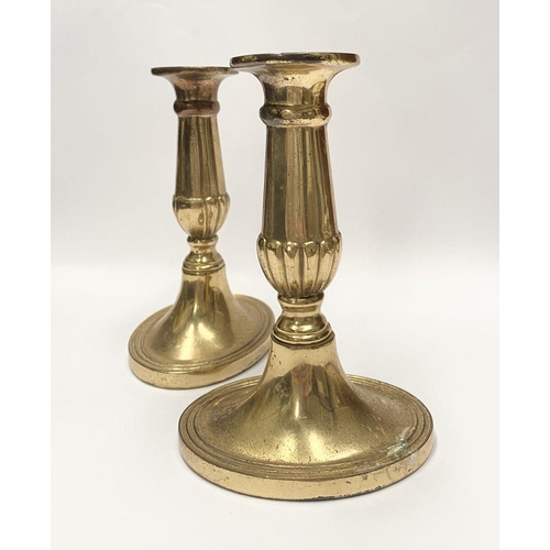 78 - A FINE PAIR OF BRASS CANDLESTICKS, with fluted design to support, atop platform oval bases. Marked M... 