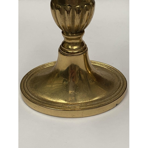 78 - A FINE PAIR OF BRASS CANDLESTICKS, with fluted design to support, atop platform oval bases. Marked M... 