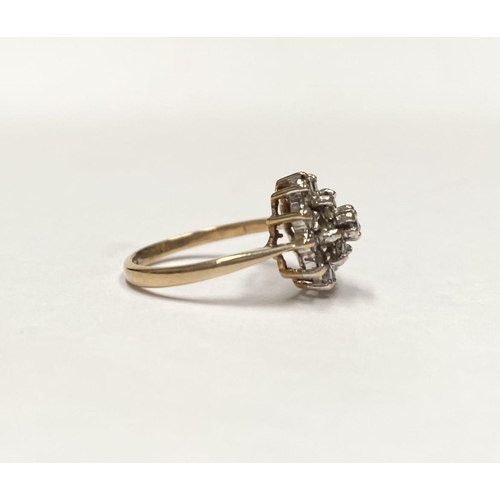 88 - AN ORNATE 9CT GOLD CLUSTER RING, with central round cut clear gemstone surrounded by two rows of gem... 