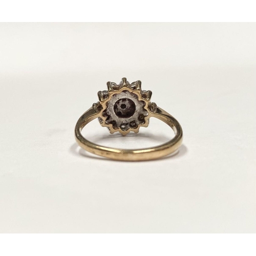 88 - AN ORNATE 9CT GOLD CLUSTER RING, with central round cut clear gemstone surrounded by two rows of gem... 