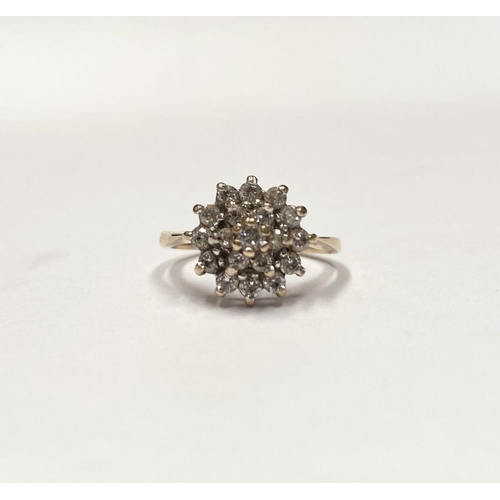 88 - AN ORNATE 9CT GOLD CLUSTER RING, with central round cut clear gemstone surrounded by two rows of gem... 