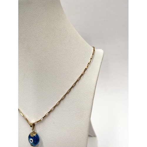 94 - A 9CT GOLD CHAIN EVIL EYE PENDANT NECKLACE, chain marked 9K to clasp. Dimensions: 26cm long approx.