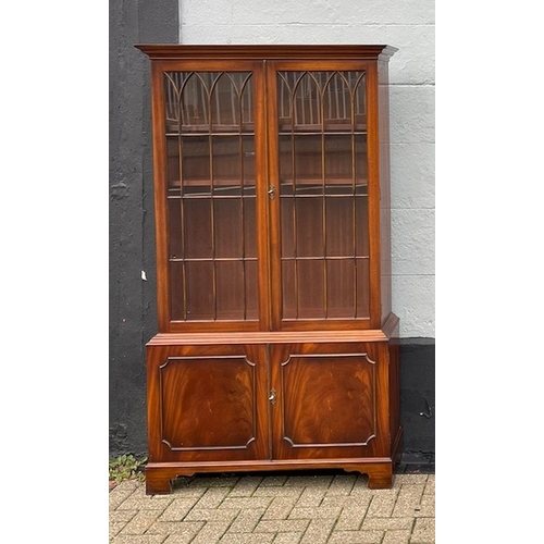 109 - A VERY GOOD QUALITY PAIR OF FLAME MAHOGANY GLAZED LIBRARY BOOKCASES, each with a pair of gothic styl... 