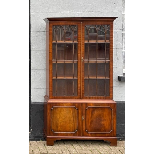 109 - A VERY GOOD QUALITY PAIR OF FLAME MAHOGANY GLAZED LIBRARY BOOKCASES, each with a pair of gothic styl... 