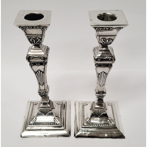 12 - A GOOD QUALITY PAIR OF LATE 19TH CENTURY SILVER CANDLESTICKS, each decorated with lovely raised scro... 