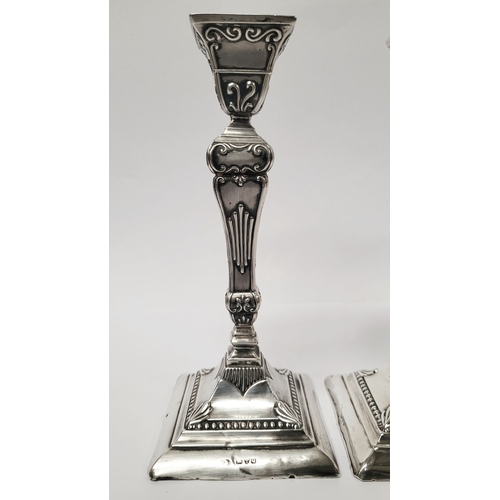 12 - A GOOD QUALITY PAIR OF LATE 19TH CENTURY SILVER CANDLESTICKS, each decorated with lovely raised scro... 