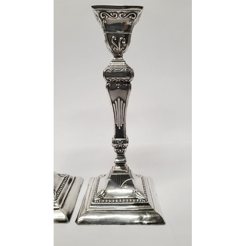 12 - A GOOD QUALITY PAIR OF LATE 19TH CENTURY SILVER CANDLESTICKS, each decorated with lovely raised scro... 