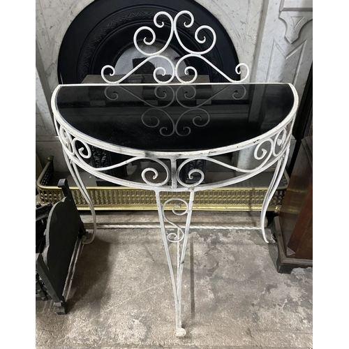 122 - A MID CENTURY WROUGHT IRON DEMI-LUNE CONSOLE TABLE, the reverse painted glass top with raised scroll... 