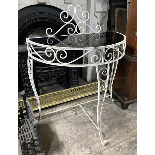 122 - A MID CENTURY WROUGHT IRON DEMI-LUNE CONSOLE TABLE, the reverse painted glass top with raised scroll... 