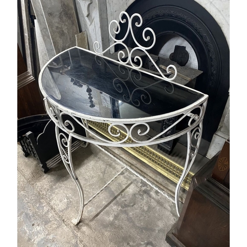 122 - A MID CENTURY WROUGHT IRON DEMI-LUNE CONSOLE TABLE, the reverse painted glass top with raised scroll... 