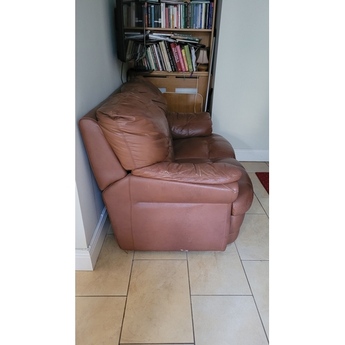 127 - A GOOD TWO SEATER TAN LEATHER COUCH, with padded back & arm rests. In fair condition; ware commensur... 