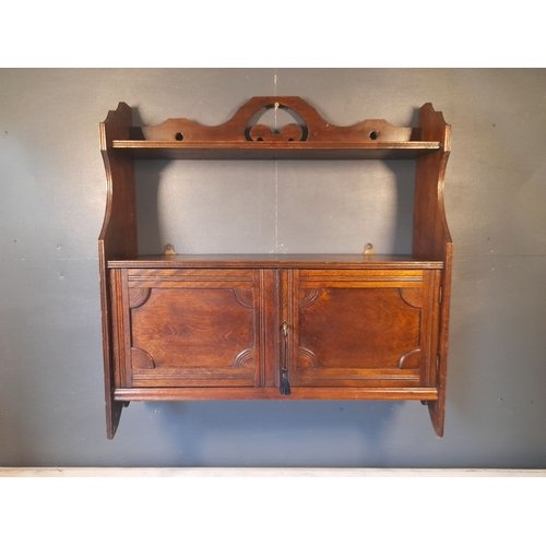 136 - A GOOD ANTIQUE WALL CUPBOARD, with working lock & key. The top with open shelf raised on a pair of s... 