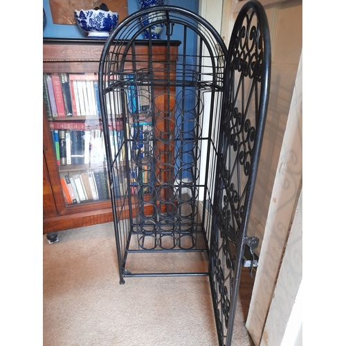 137 - A VERY GOOD, HEAVY, SPANISH STYLE WROUGHT IRON FLOOR STNADING WINE CAGE, lockable, holds 24 bottles.... 