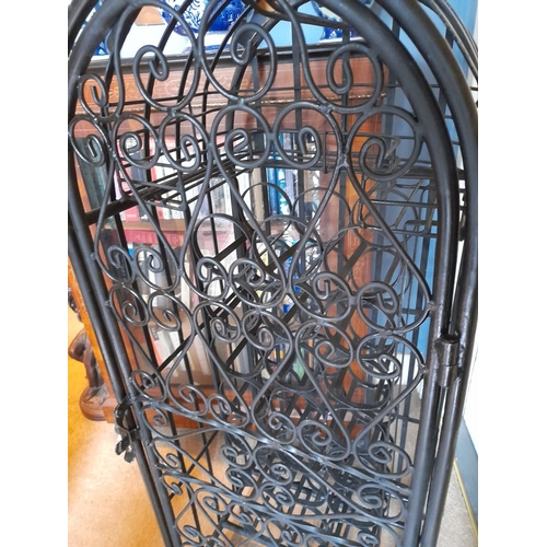 137 - A VERY GOOD, HEAVY, SPANISH STYLE WROUGHT IRON FLOOR STNADING WINE CAGE, lockable, holds 24 bottles.... 