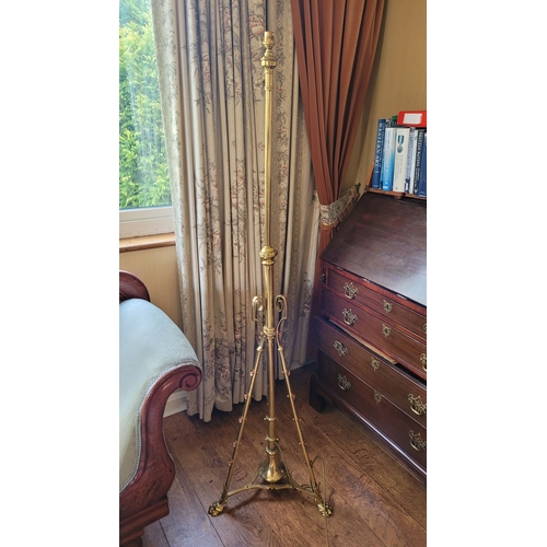 17 - A VERY GOOD QUALITY WROUGHT BRASS STANDARD LAMP, with scrolling supports dotted with copper coloured... 