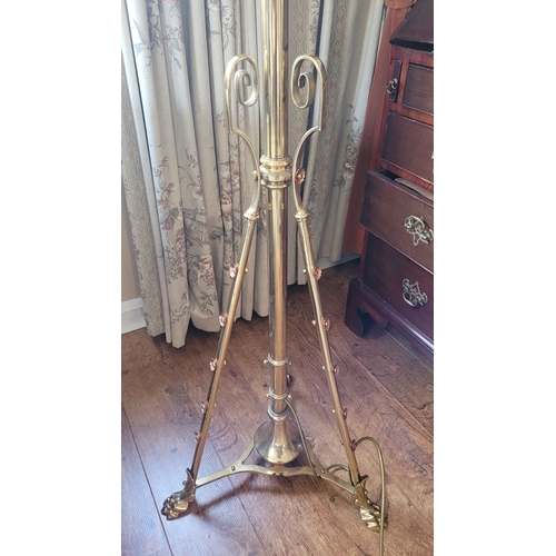 17 - A VERY GOOD QUALITY WROUGHT BRASS STANDARD LAMP, with scrolling supports dotted with copper coloured... 